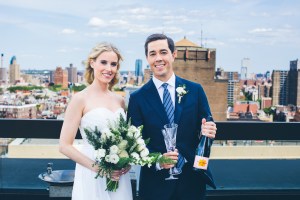 Groom getting ready to open champagne on NYC rooftop. Affordable photographers NYC.